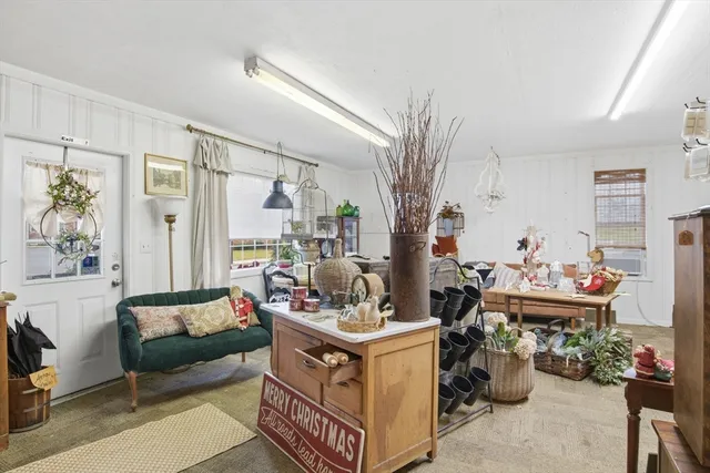 a view of a dining room and livingroom with furniture wooden floor and a rug