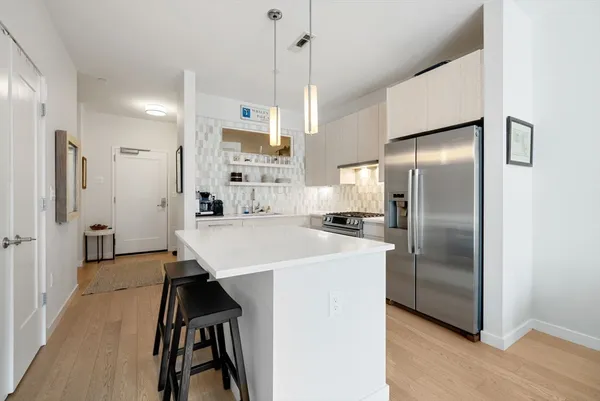 a kitchen with stainless steel appliances a refrigerator sink and stove