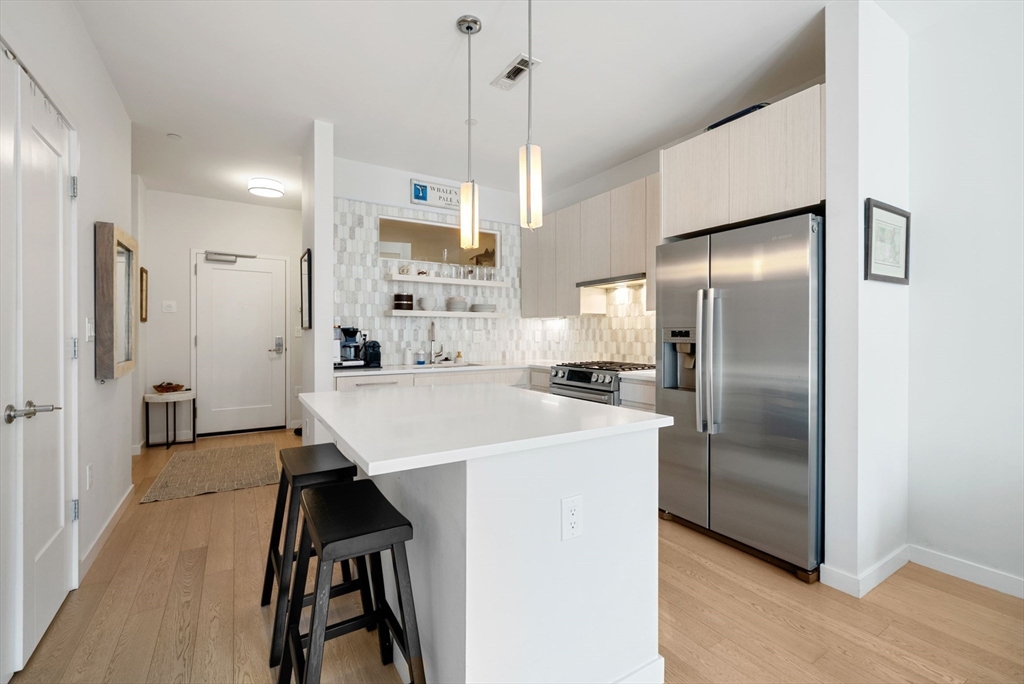 45 West 3rd Street, Unit 406 Boston, MA 02127 - Photo 6 of 14 a kitchen with stainless steel appliances a refrigerator sink and stove