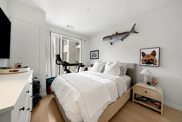 a bedroom with bed and a window