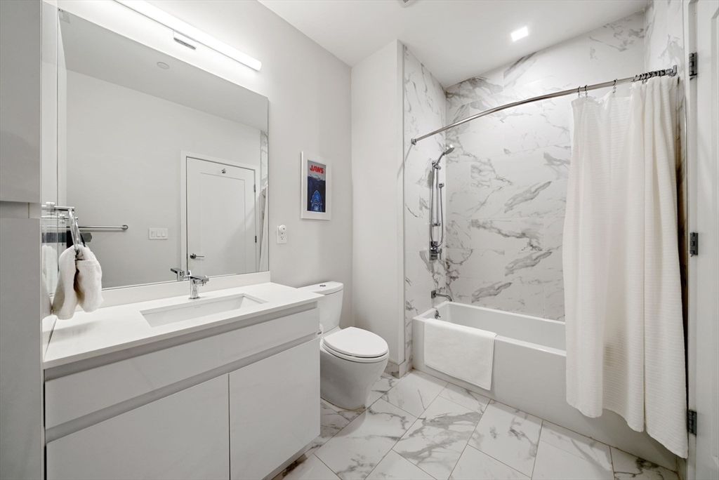 45 West 3rd Street, Unit 406 Boston, MA 02127 - Photo 9 of 14 a bathroom with a sink toilet and shower