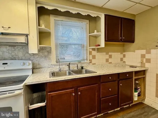a kitchen with a sink and cabinets