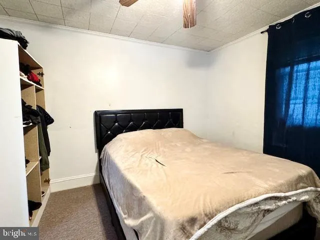 a bed sitting in a bedroom next to a window