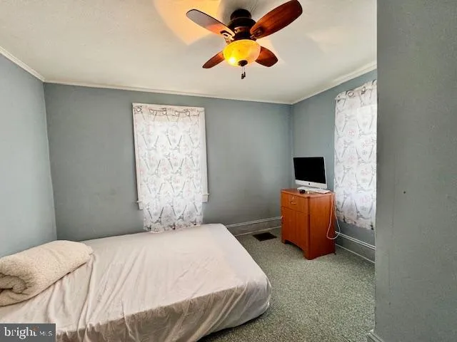 a bedroom with a bed and a tv