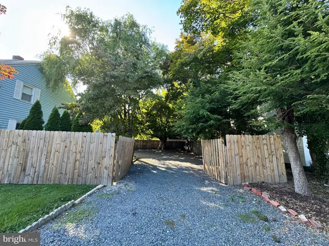 a view of backyard with a barn and large trees
