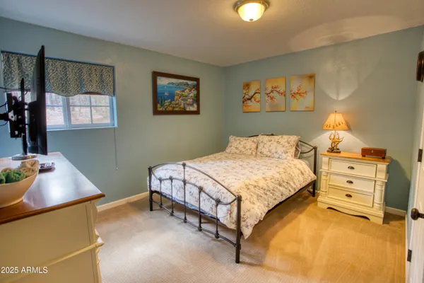 a bedroom with a bed and a dresser