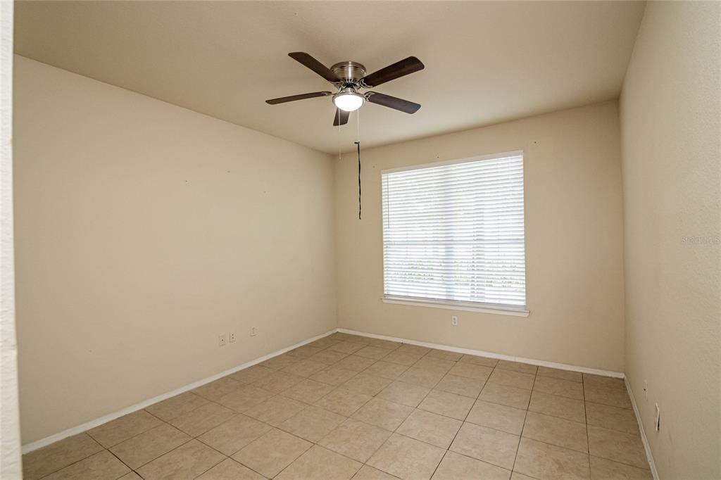3391 South Kirkman Road, Unit 1216 Orlando, FL 32811 - Photo 24 of 33 an empty room with a ceiling fan and window