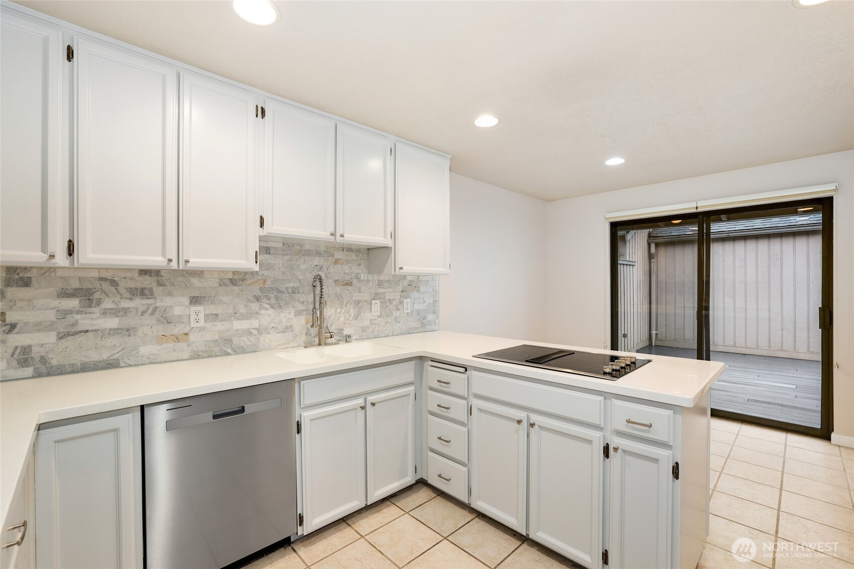 2940 Kennewick Place Northeast Renton, WA 98056 - Photo 11 of 37 a kitchen with granite countertop white cabinets white appliances and a sink