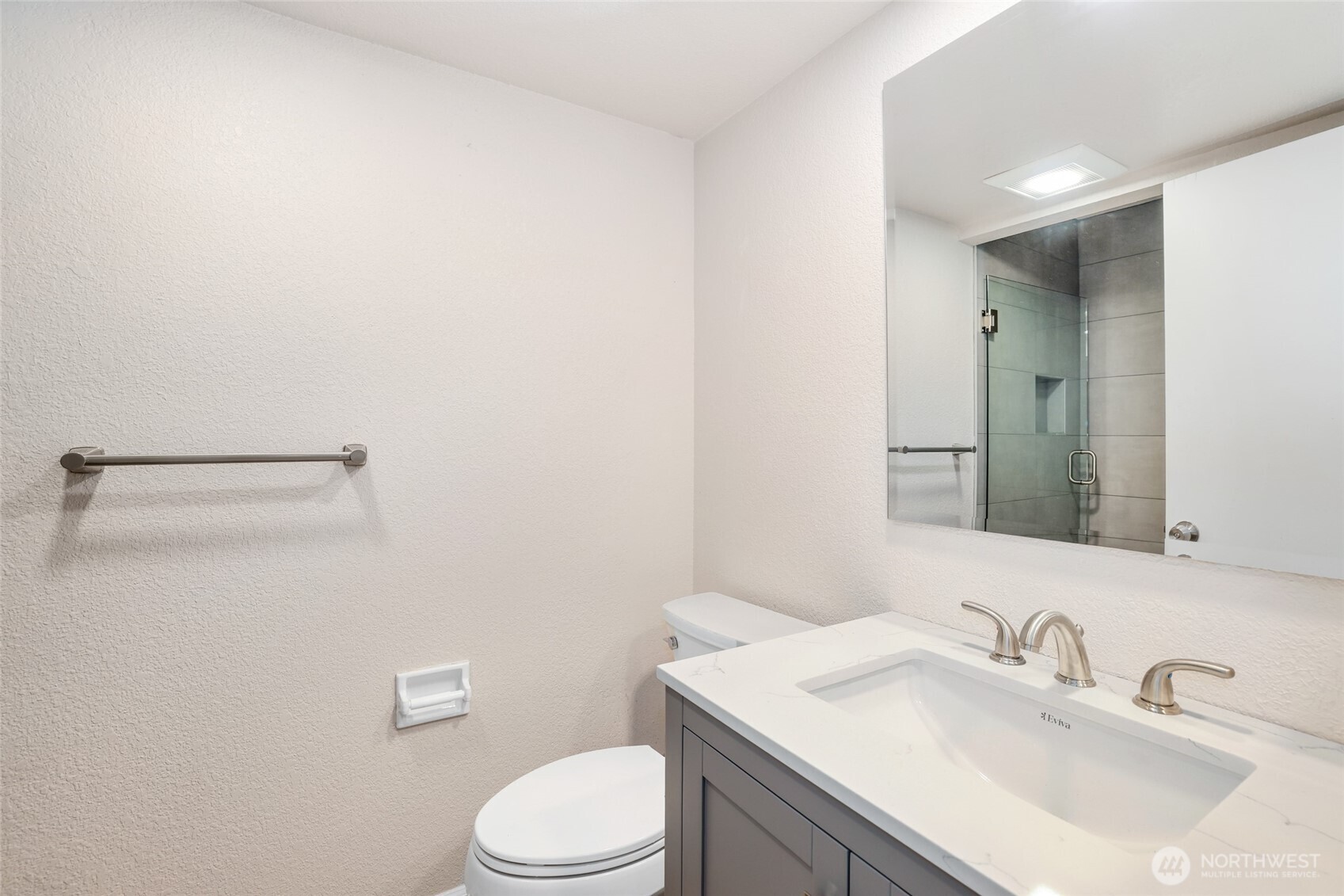 2940 Kennewick Place Northeast Renton, WA 98056 - Photo 20 of 37 a bathroom with a sink a toilet and mirror
