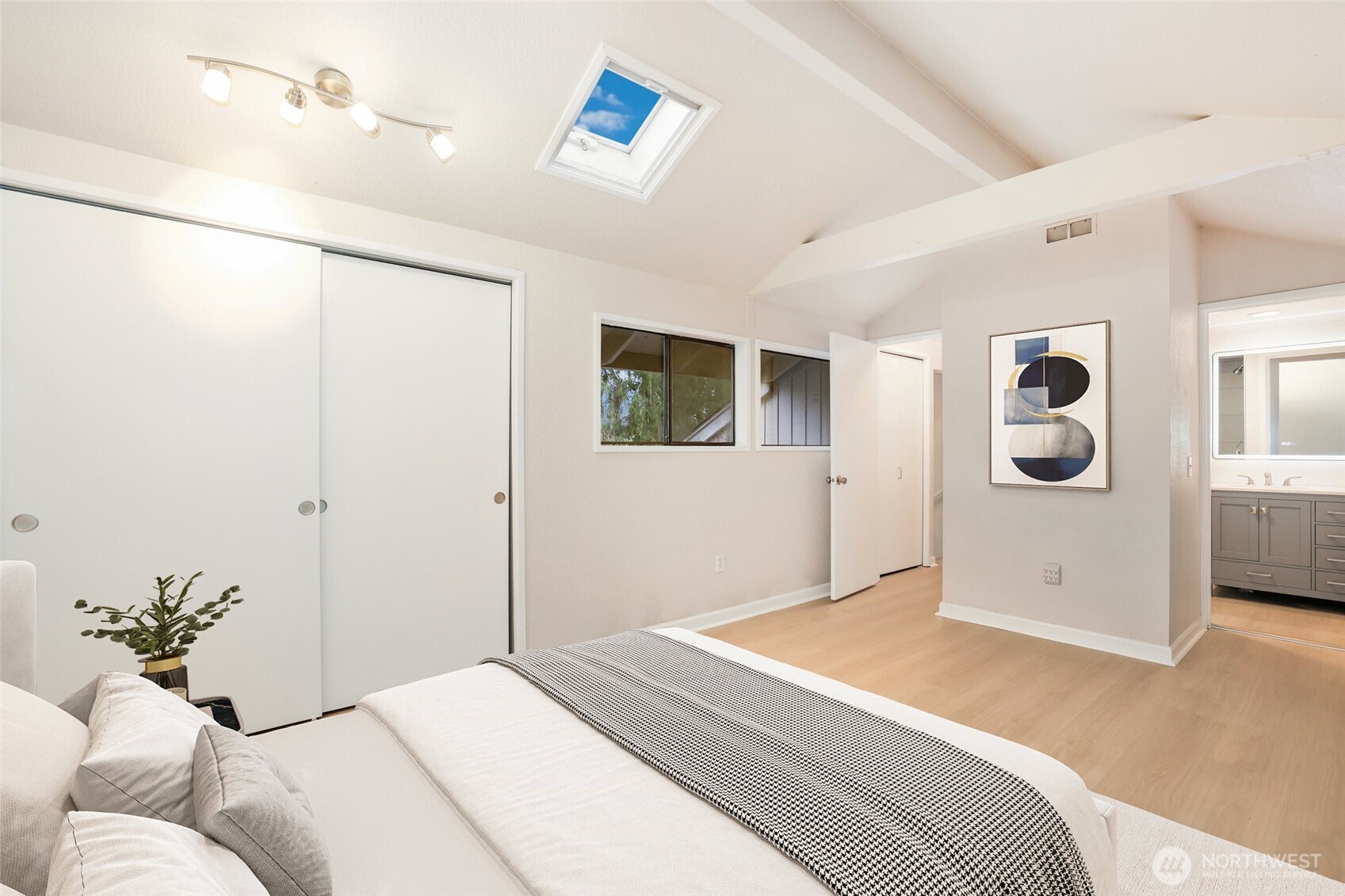 2940 Kennewick Place Northeast Renton, WA 98056 - Photo 22 of 37 a bedroom with a large bed and a chandelier