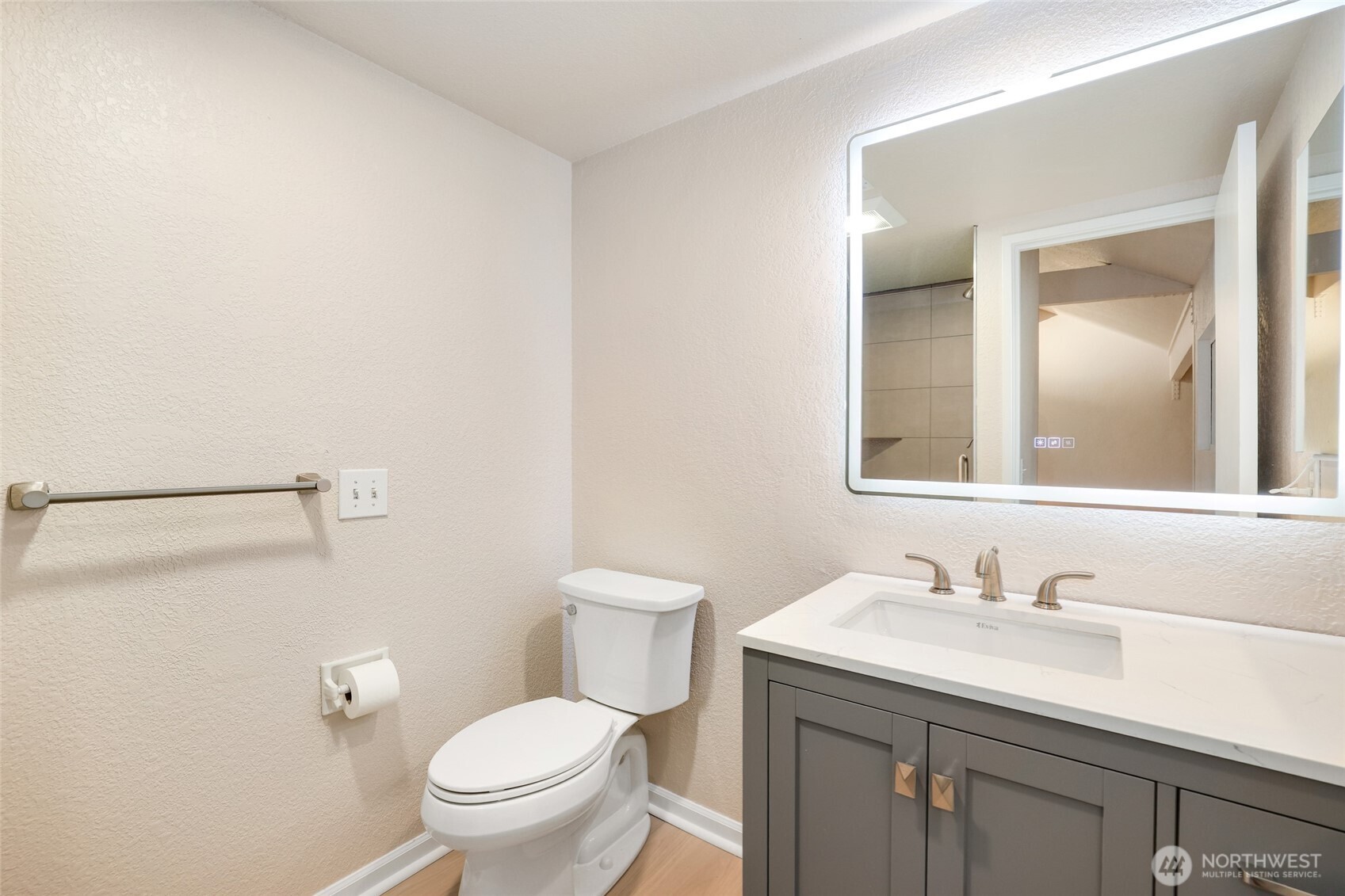 2940 Kennewick Place Northeast Renton, WA 98056 - Photo 23 of 37 a bathroom with a granite countertop sink a toilet and a mirror