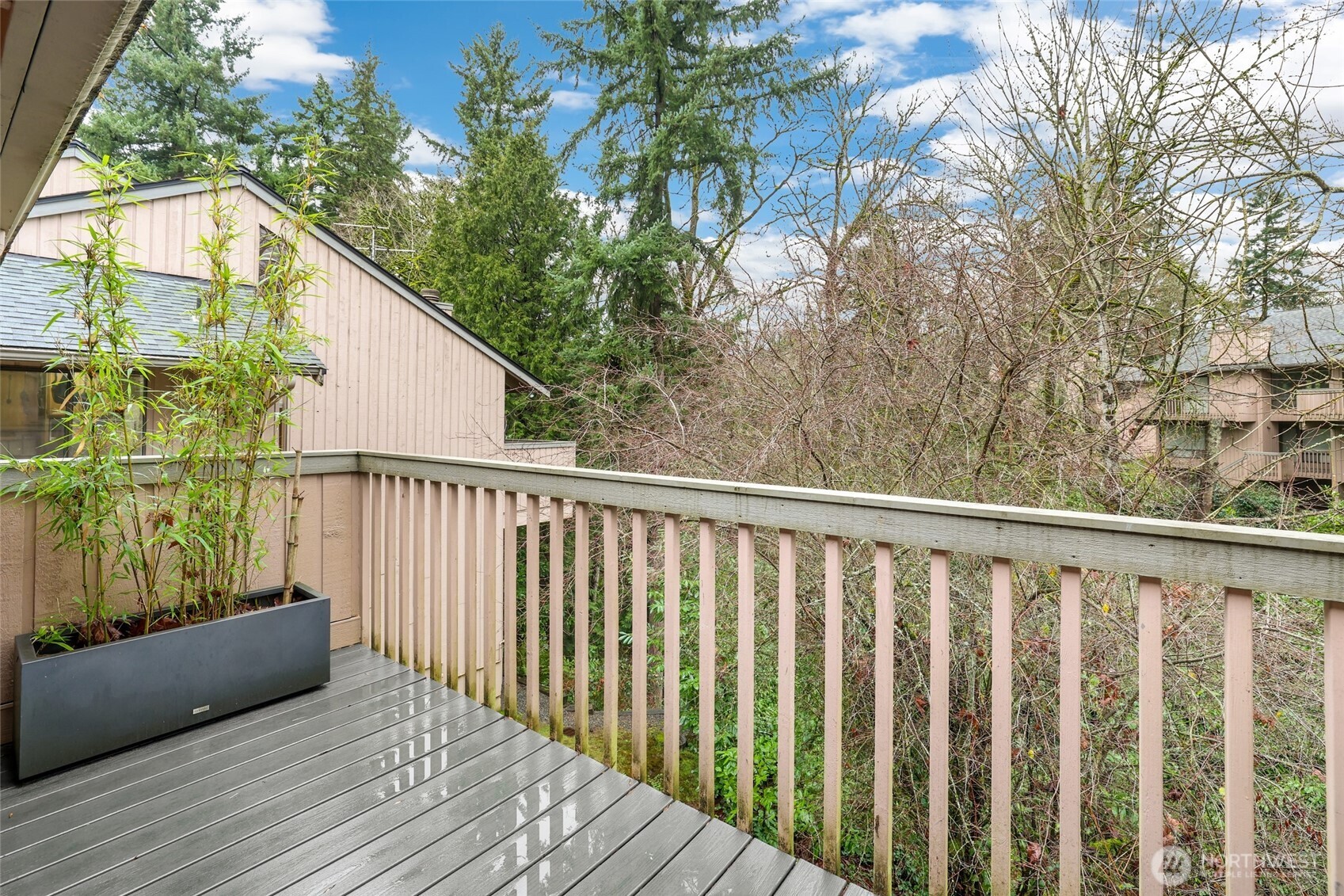 2940 Kennewick Place Northeast Renton, WA 98056 - Photo 26 of 37 a balcony with wooden floor and trees in the back