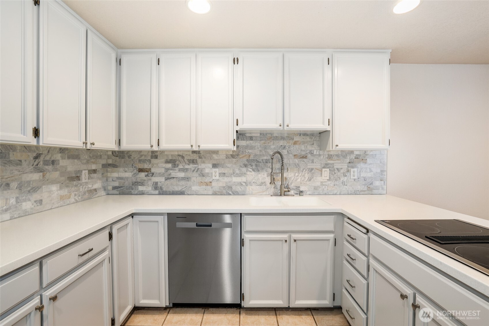2940 Kennewick Place Northeast Renton, WA 98056 - Photo 10 of 37 a kitchen with stainless steel appliances granite countertop a sink stove and cabinets