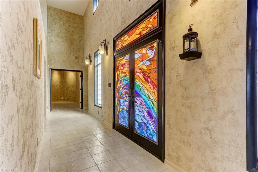 5552 Drake Road Greensboro, NC 27406 - Photo 2 of 29 Enter into this awesome foyer. The stainglass in this home is breath taking. Made just for these doors.