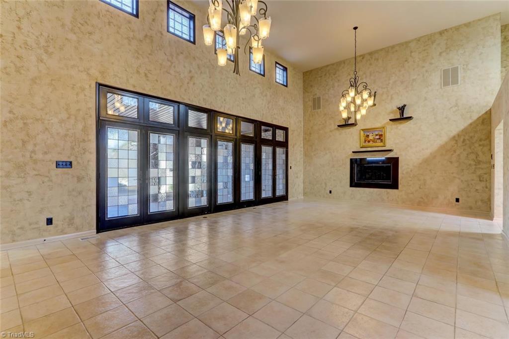 5552 Drake Road Greensboro, NC 27406 - Photo 3 of 29 As you just left the foyer on the right side of the picture, you enter this enormous living room. The stain glass doors go to the patio.