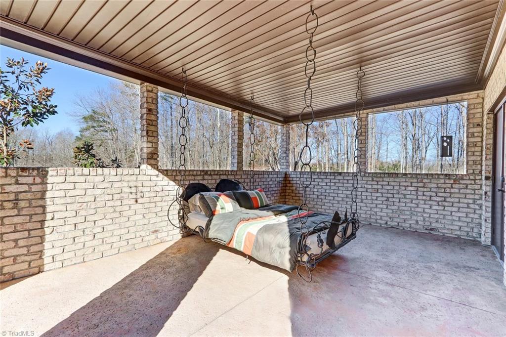 5552 Drake Road Greensboro, NC 27406 - Photo 22 of 29 outside of the master bedroom... covered porch with a swinging bed