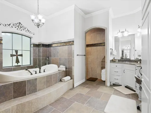 a spacious bathroom with a double vanity sink a mirror a bathtub and shower