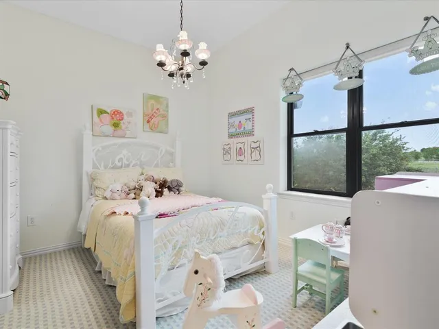 a bedroom with a bed and a chandelier