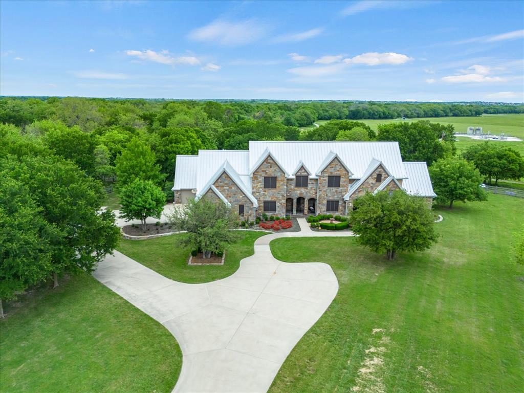 8970 Burnett Road Justin, TX 76247 - Photo 38 of 40 a view of a big house with a big yard and potted plants in front of the house