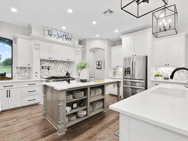 a kitchen with stainless steel appliances a sink stove and refrigerator