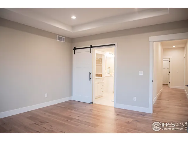 a view of an empty room and wooden floor