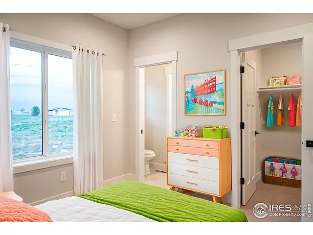 a bed room with a bed and a window