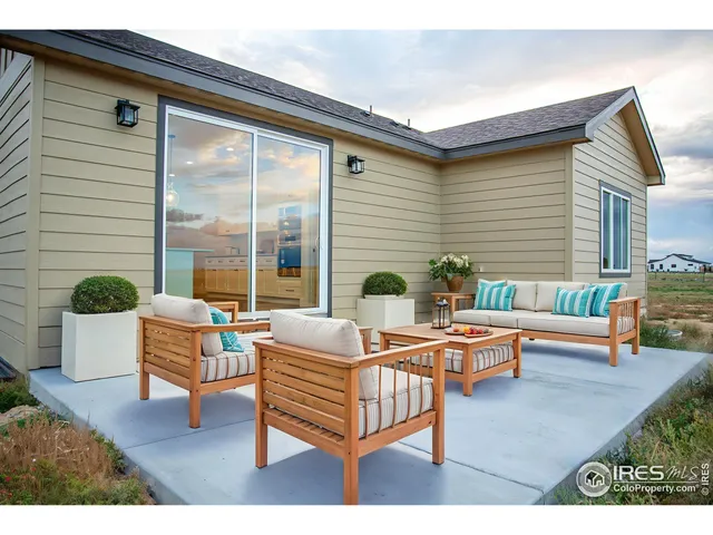 a outdoor space with patio the couches and a dining table with the potted plants