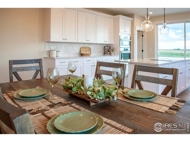 a kitchen with a table and chairs
