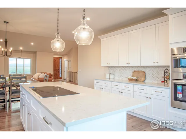 a kitchen with kitchen island granite countertop a sink a stove and cabinets