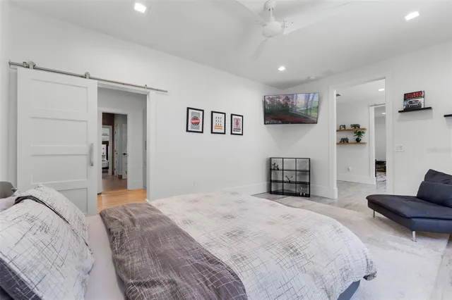 a bedroom with a large bed and a chandelier