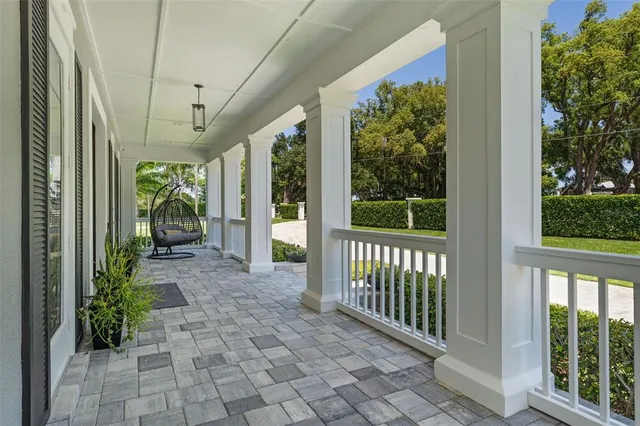 a living room with furniture ceiling fan and a large window