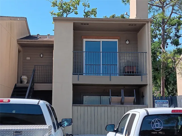 a view of a livingroom with furniture and staircase
