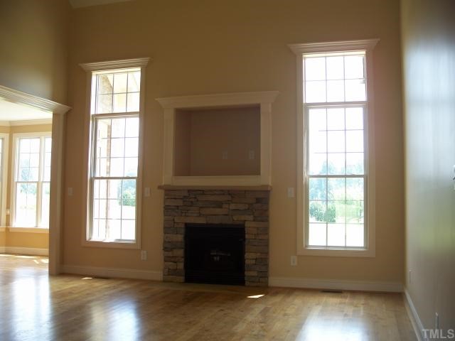 65 North Old Lantern Road Timberlake, NC 27583 - Photo 3 of 12 a living room with a fireplace and wooden floor