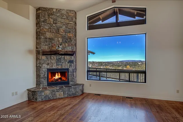 a living room with a fireplace and a floor to ceiling window