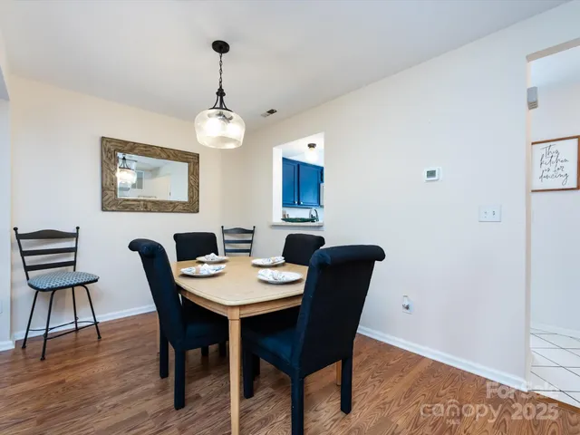 a view of a dining room with furniture wooden floor and chandelier