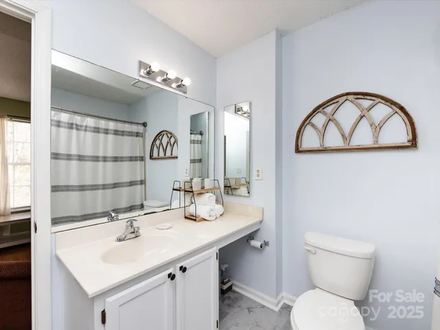 a bathroom with a toilet sink and a shower