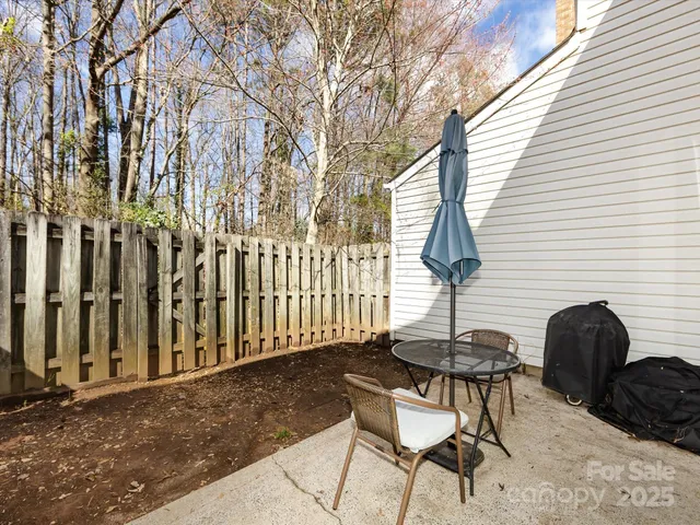 a backyard of a house with table and chairs