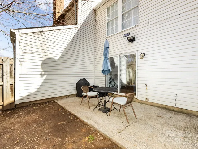 a balcony with table and chairs