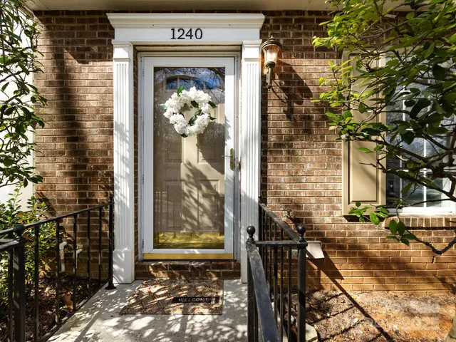 a kitchen with granite countertop a refrigerator and a stove top oven
