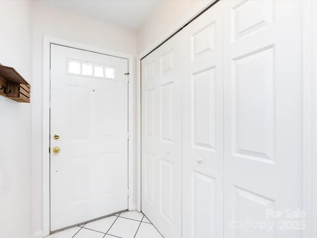 a kitchen with a sink a stove top oven and white cabinets