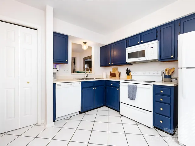a kitchen with a sink a stove and cabinets