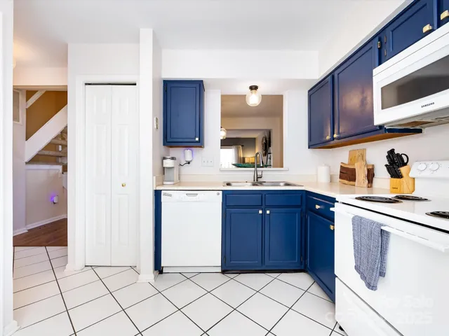 a kitchen with a stove a sink and a refrigerator
