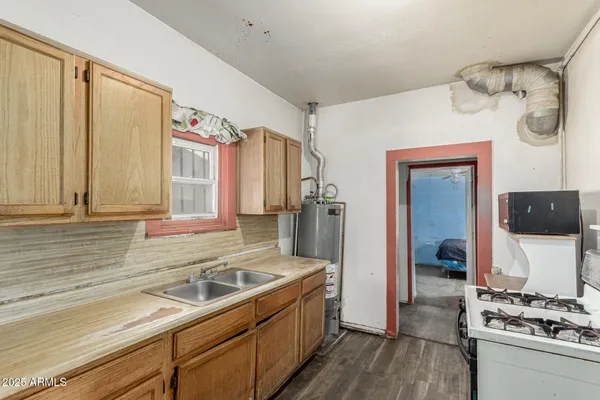 a kitchen with a sink stove and refrigerator