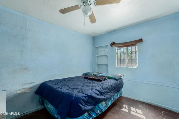 a bedroom with a bed and window