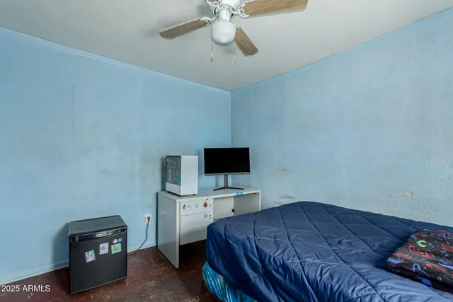 a bedroom with a bed and a tv