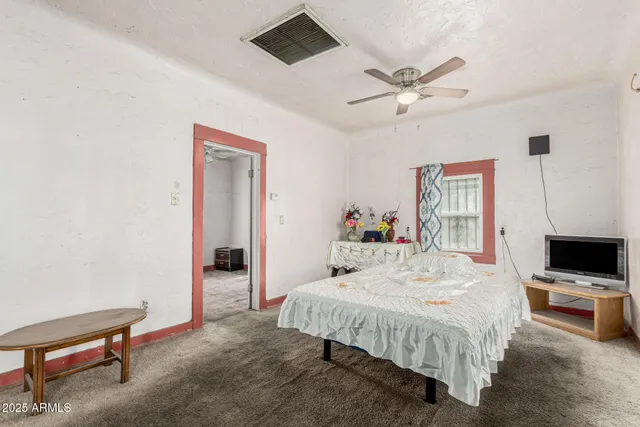 a bedroom with a bed and a desk