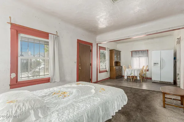 a bedroom with a large bed and a window