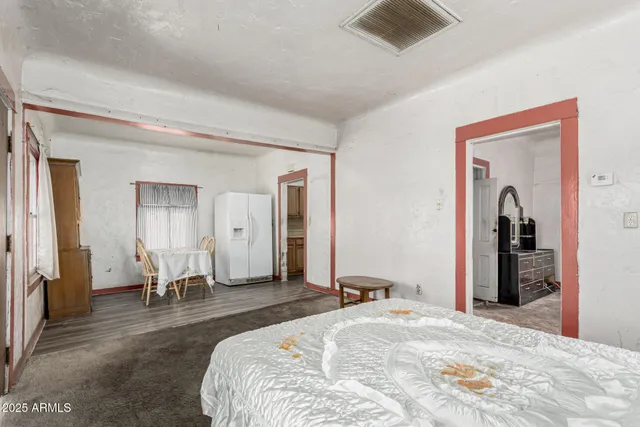 a bedroom with a bed and a couch