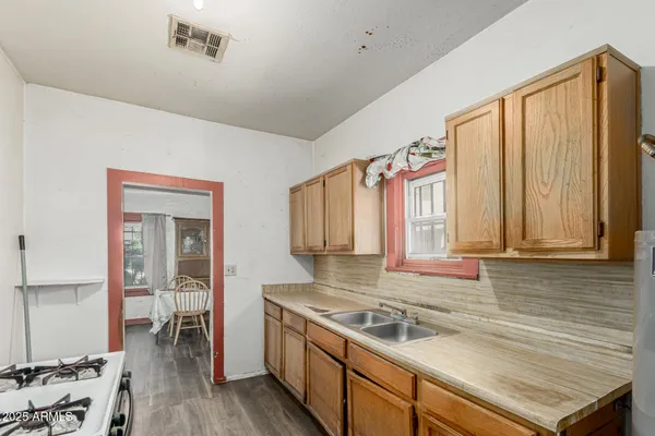 a kitchen that has a sink and a stove in it