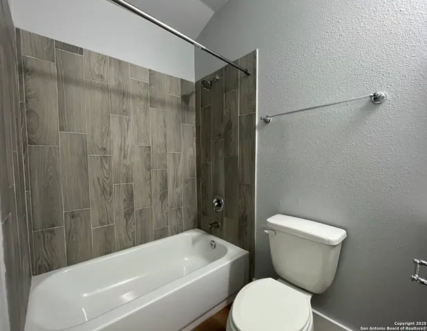 a bathroom with a toilet and a bathtub